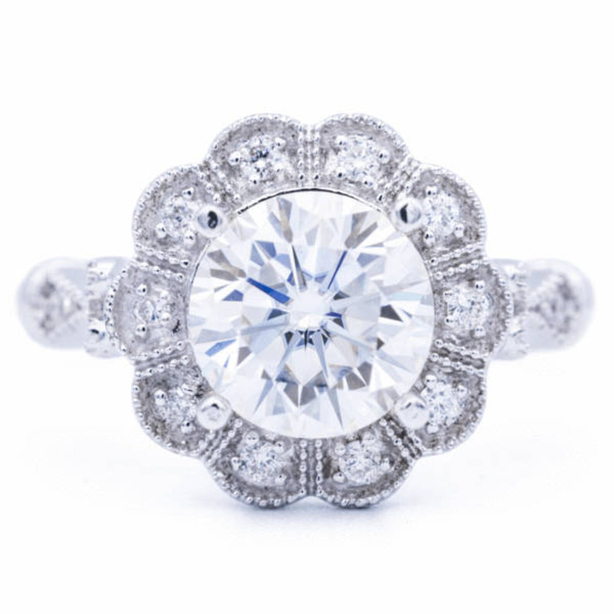 Direct top-down symmetry view of 3 CT round brilliant lab grown diamond inside floral scalloped halo bezel