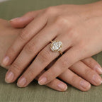 On-hand view of a 3 carat oval lab grown diamond engagement ring with a vintage scalloped diamond halo in yellow gold.