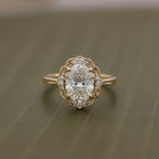 Top-down view of a 3 CT oval lab grown diamond ring with a scalloped halo accent frame and milgrain band.