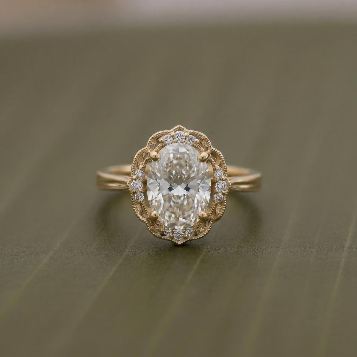 Top-down view of a 3 CT oval lab grown diamond ring with a scalloped halo accent frame and milgrain band.