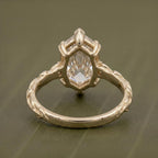 Under-gallery and back view of a 4 CT Dutch marquise cut lab grown diamond ring showing the 6-prong yellow gold basket and sculpted leaf band.
