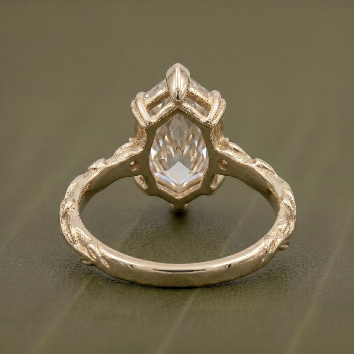 Under-gallery and back view of a 4 CT Dutch marquise cut lab grown diamond ring showing the 6-prong yellow gold basket and sculpted leaf band.