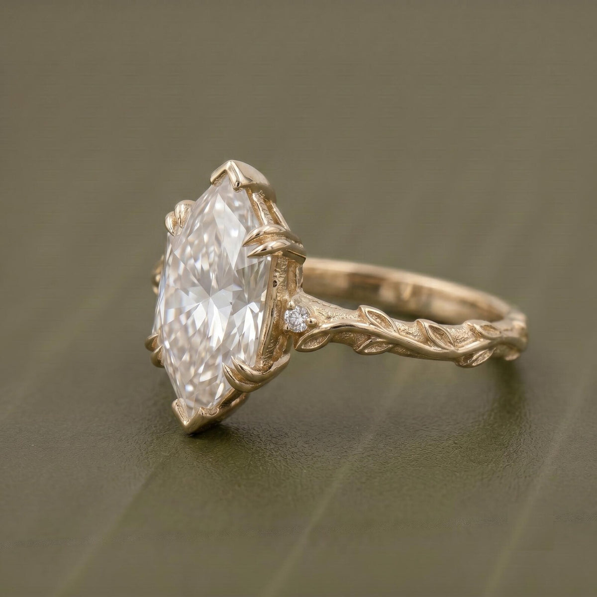 Side profile of a 4 carat Dutch marquise lab grown diamond ring featuring a hand-carved botanical vine band and prong setting in yellow gold.