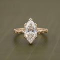 Top-down front view of a 4 CT Dutch marquise cut lab grown diamond solitaire engagement ring with V-prongs and a carved vine band.