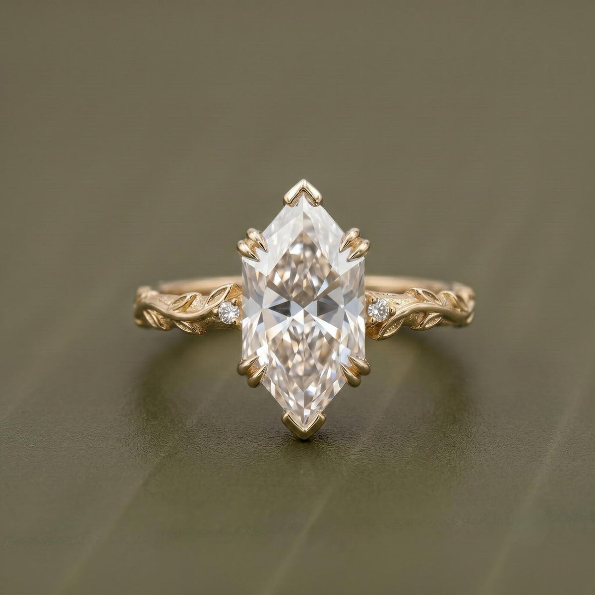 Top-down front view of a 4 CT Dutch marquise cut lab grown diamond solitaire engagement ring with V-prongs and a carved vine band.