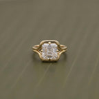 Top-down view highlighting the step-cut facets of a 2 CT Asscher lab diamond in a yellow gold frame.