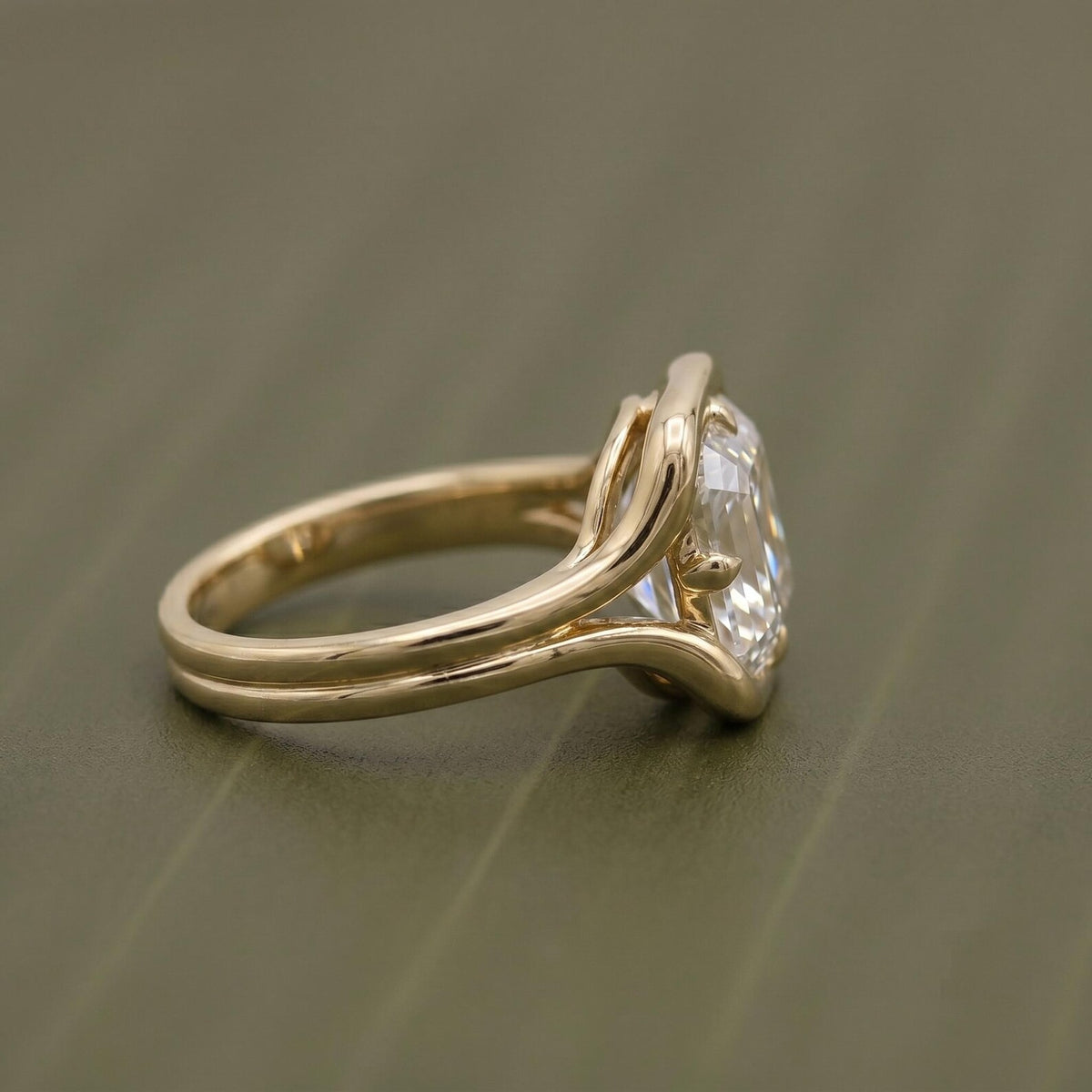 Detailed view of 2 carat Asscher cut lab diamond ring resting on beige fabric.