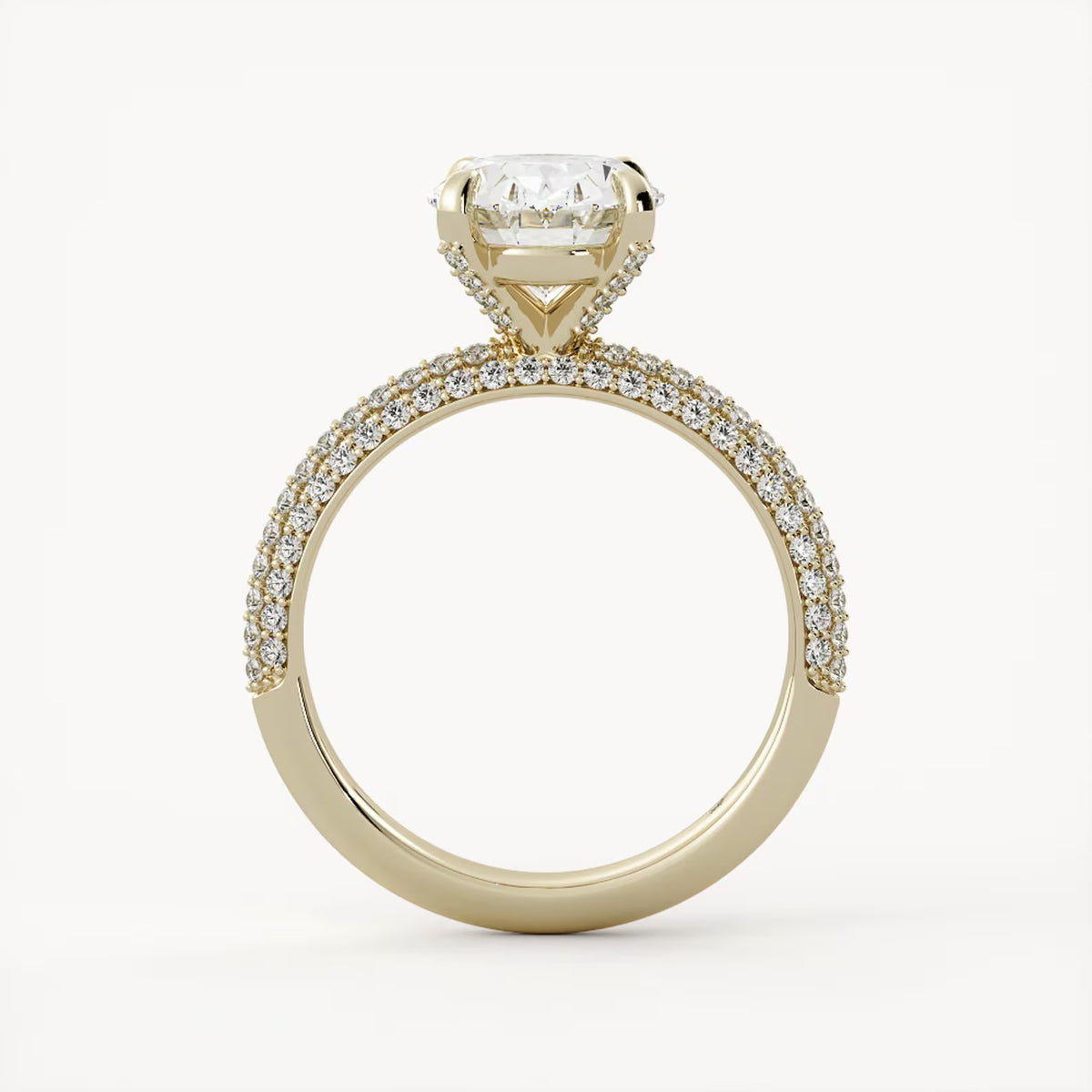 Side profile view of a yellow gold oval lab diamond ring featuring a hidden halo collar and cathedral setting.