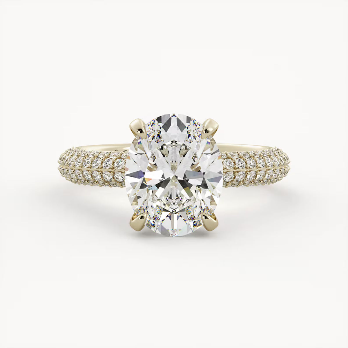 Front view of a 2 CT oval lab grown diamond engagement ring set in 14K yellow gold with a triple-row micro-pavé band.