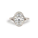 Studio macro shot of a 3 carat oval lab diamond solitaire engagement ring crafted in 14k white gold with milgrain edge.