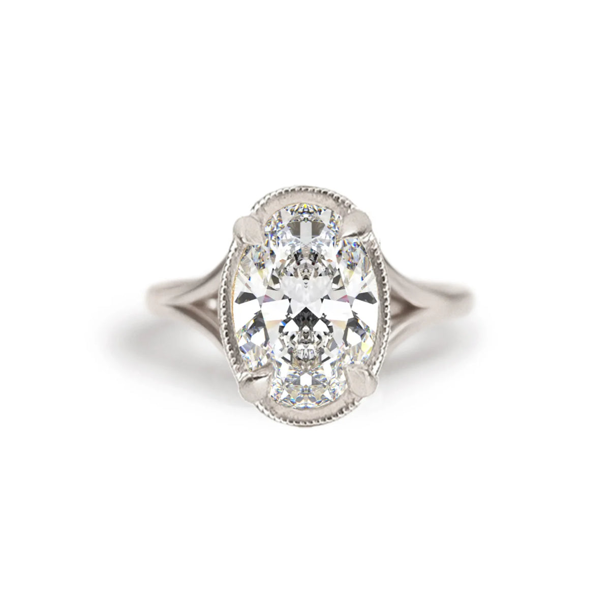 Studio macro shot of a 3 carat oval lab diamond solitaire engagement ring crafted in 14k white gold with milgrain edge.