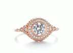 Top-down view of a 3 CT round cut lab grown diamond engagement ring in rose gold with a milgrain halo and engraved band.