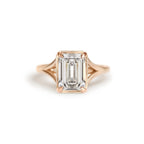 Front studio view of a 3 carat emerald cut lab created diamond engagement ring crafted in 14k rose gold with milgrain edging.