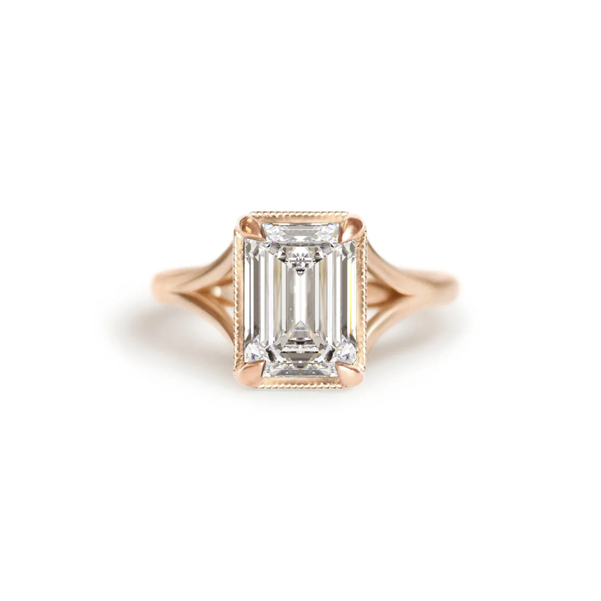 Front studio view of a 3 carat emerald cut lab created diamond engagement ring crafted in 14k rose gold with milgrain edging.