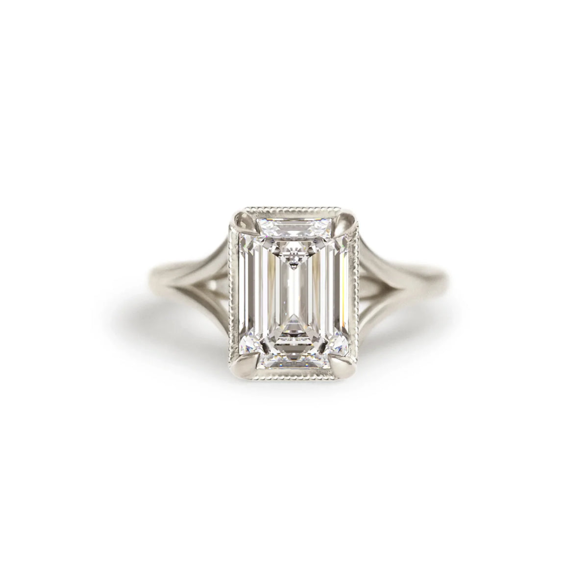 Front studio macro view of a 3 carat emerald cut lab diamond solitaire ring set in white gold or platinum with a milgrain bezel.