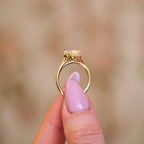 Studio top-down view of a 3 carat marquise cut lab grown diamond engagement ring in rose gold with milgrain bezel frame and split shank.