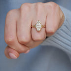 Studio macro top view of a 3 carat marquise lab created diamond engagement ring crafted in white gold or platinum with milgrain detail.