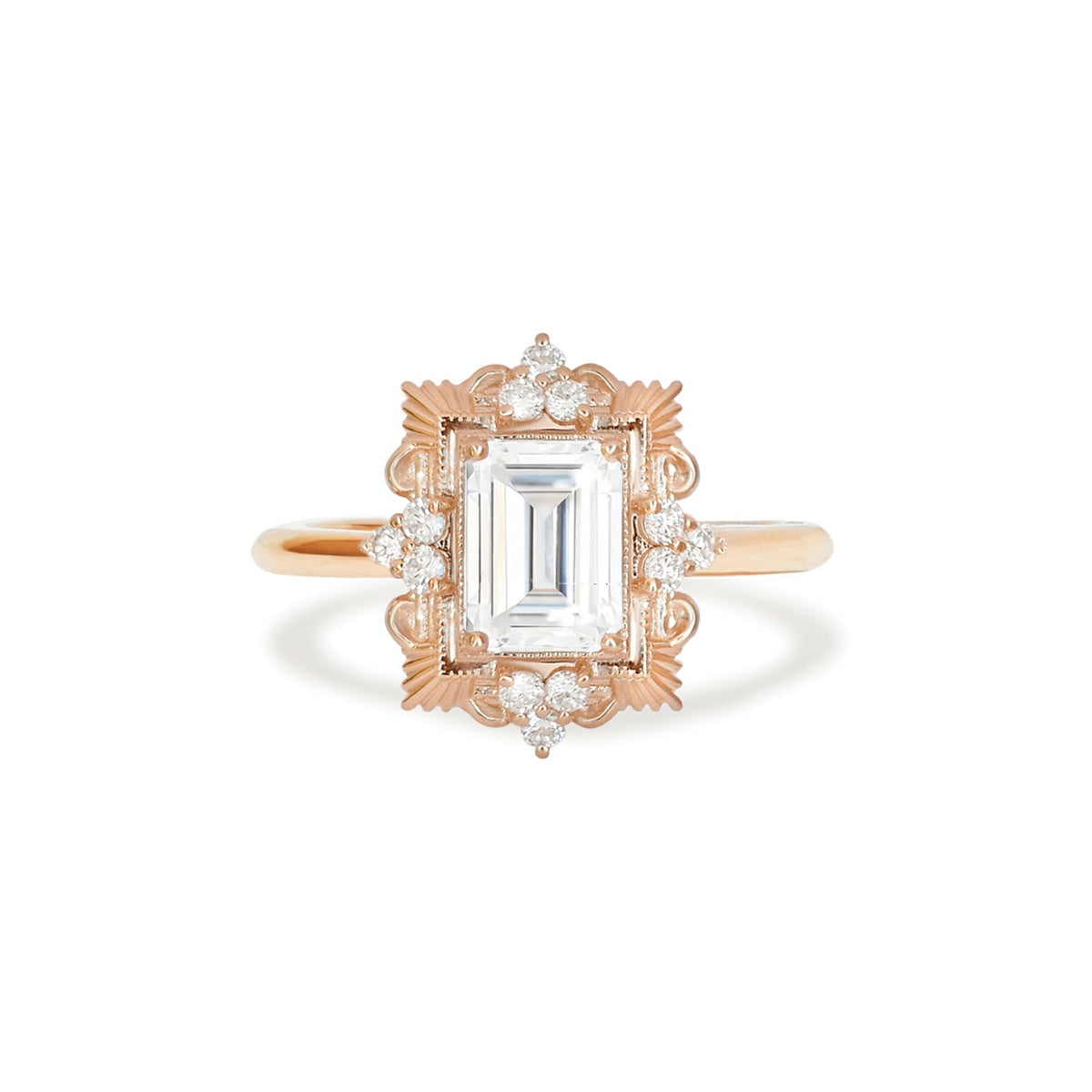 Studio top-down view of a 3 carat emerald cut lab grown diamond engagement ring crafted in 14k rose gold with an ornate Art Deco filigree halo frame.