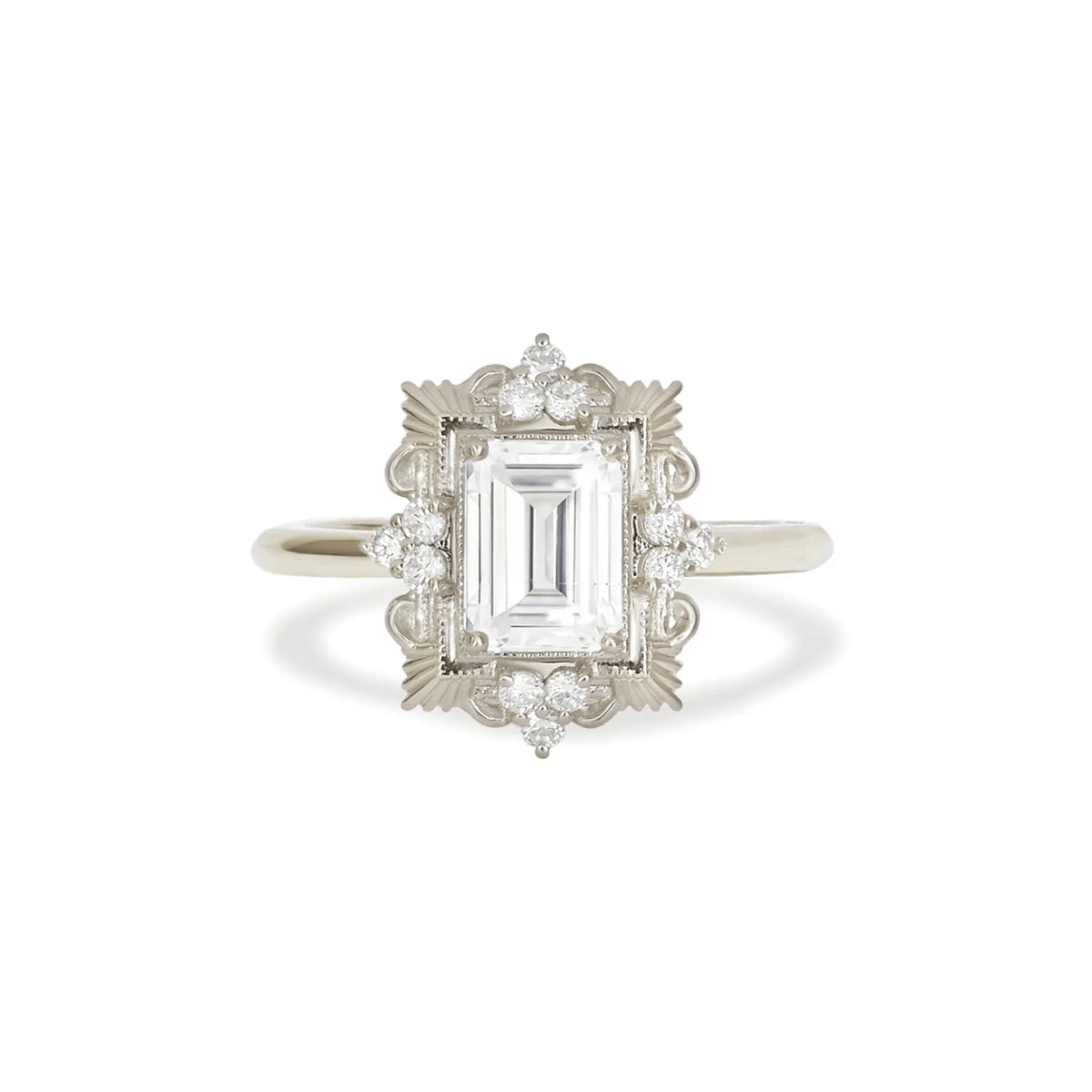 Front studio shot of a 3 carat emerald cut lab diamond ring set in white gold or platinum with an antique sunburst halo frame.