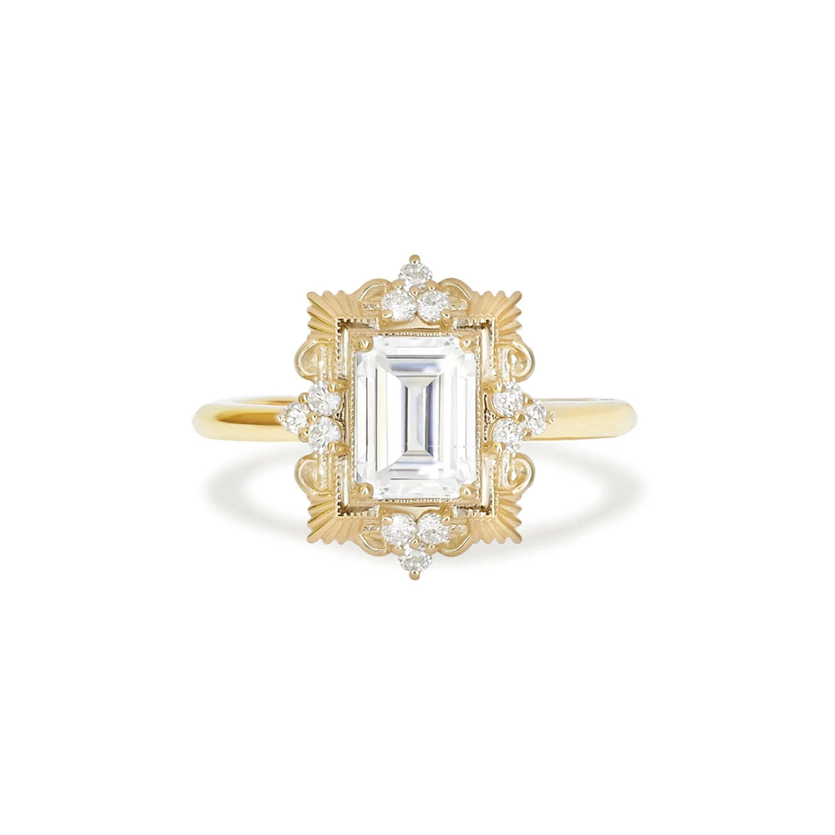 Studio macro front view of a 3 carat emerald cut lab grown diamond ring in 14k yellow gold with detailed vintage filigree halo.