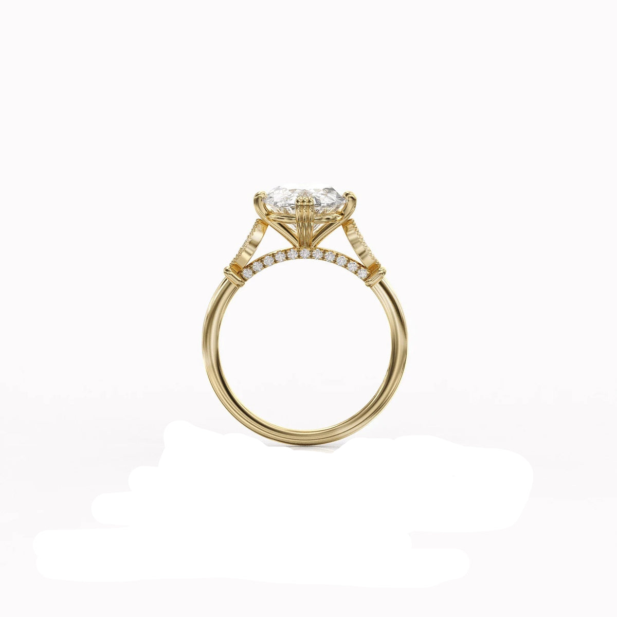 Side profile view of a 4 CT oval lab grown diamond engagement ring in yellow gold showing the hidden diamond bridge and textured prongs.