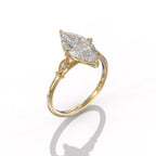Perspective angle of a 3 CT marquise lab created diamond engagement ring in yellow gold with protective V-prongs.