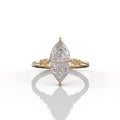 Top-down view of a 3 carat marquise lab grown diamond engagement ring in yellow gold showcasing brilliant cut facets and 6-prong setting.