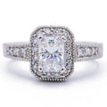 Top view of a 3 CT radiant lab grown diamond engagement ring with vintage milgrain halo and accent diamond band.