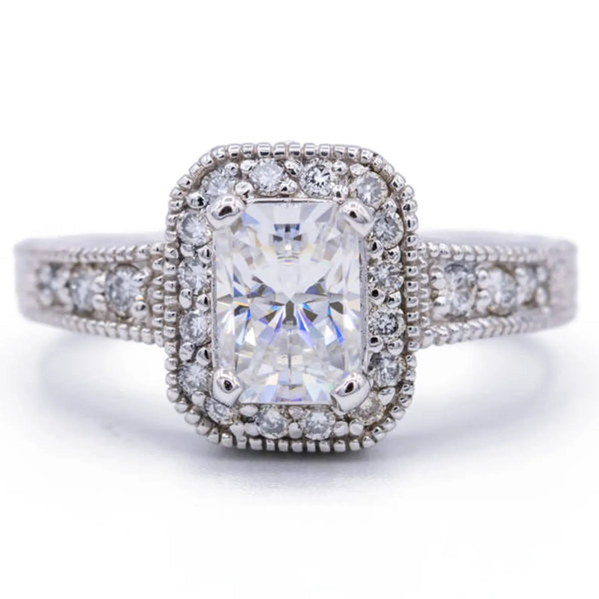 Top view of a 3 CT radiant lab grown diamond engagement ring with vintage milgrain halo and accent diamond band.