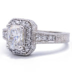 Three-quarter view of 3 carat radiant lab grown diamond ring displaying milgrain halo and hand-engraved side band details.