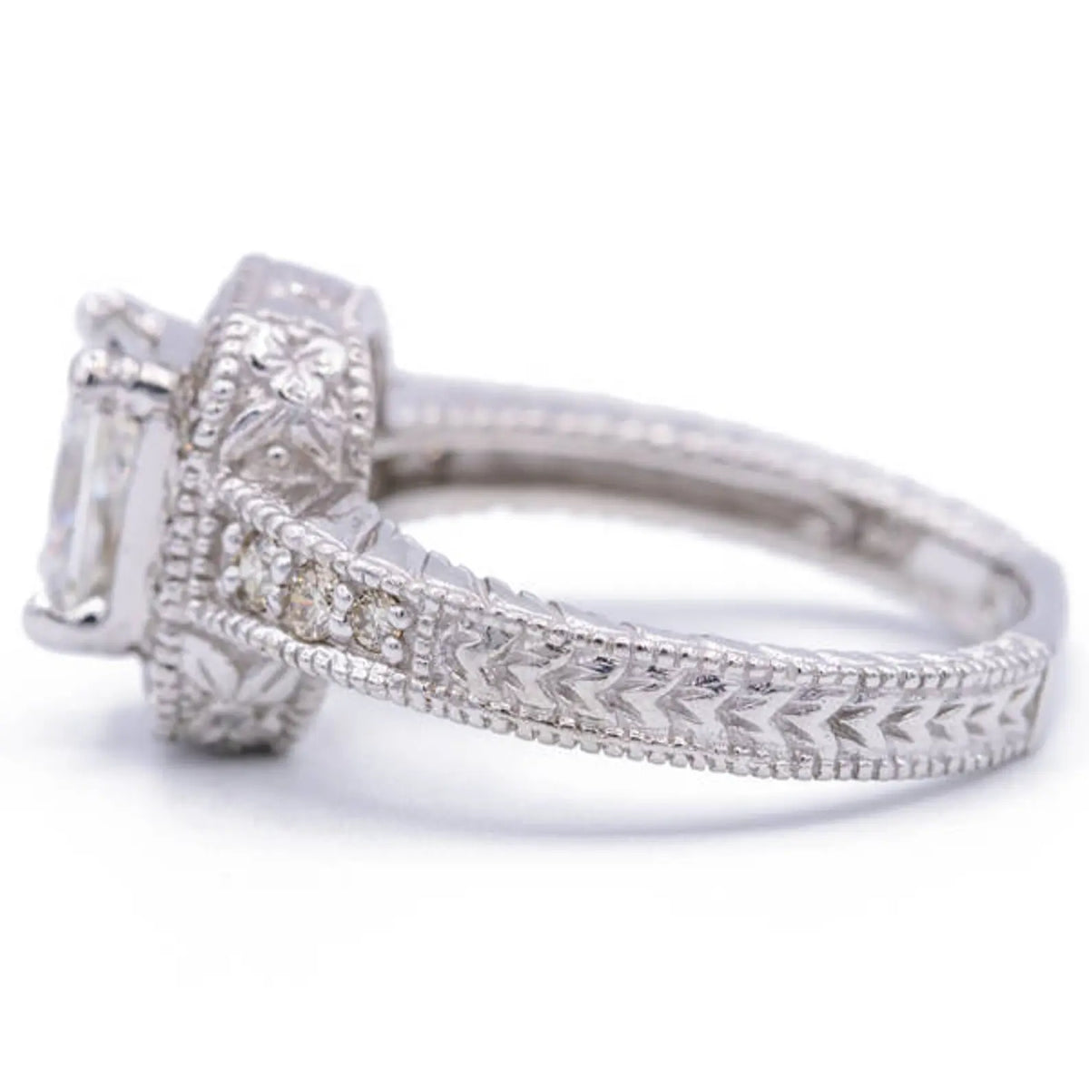 Side profile view of radiant lab diamond ring highlighting intricate wheat motif hand-engraving along the outer shank.