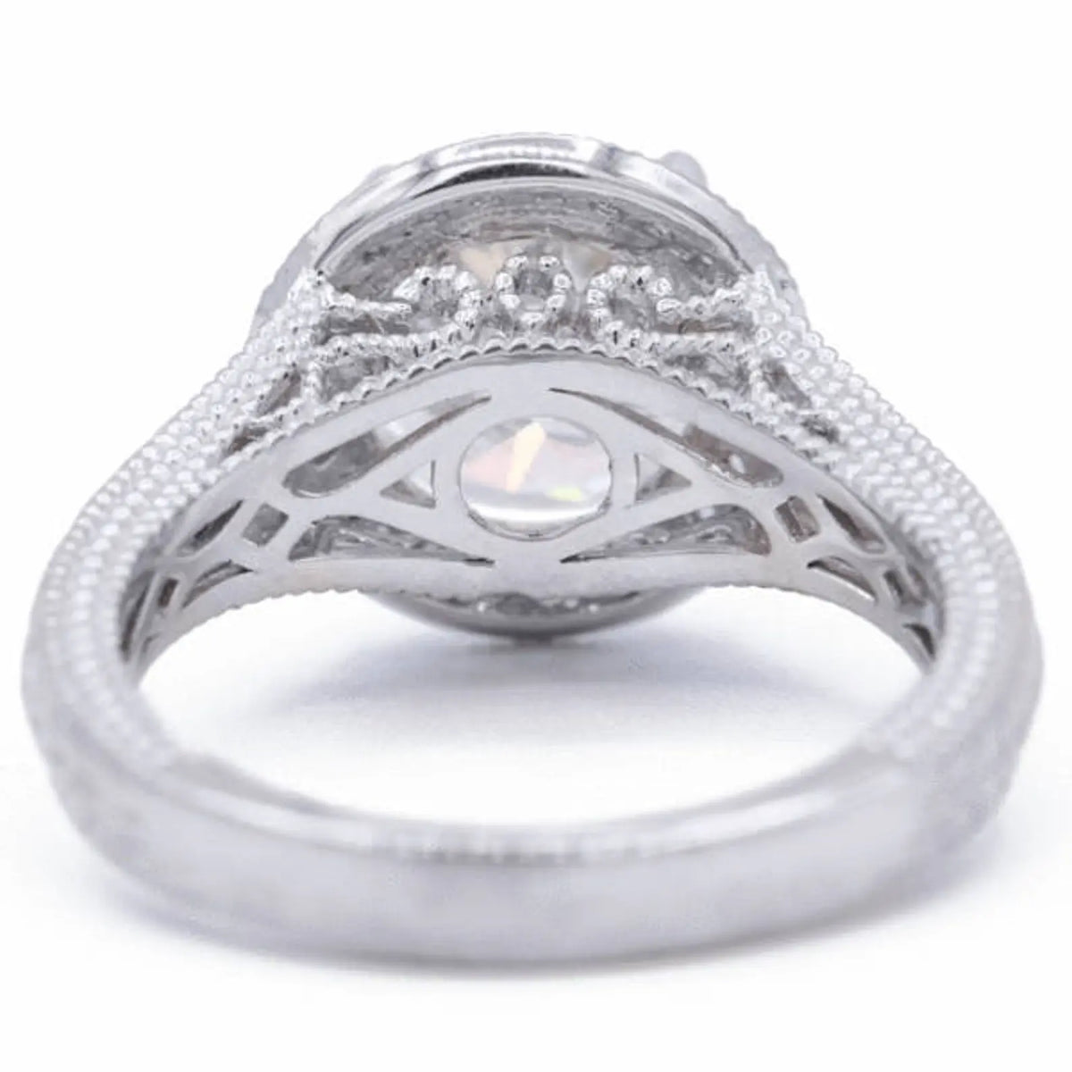 Underside profile view of a 3 CT round lab grown diamond engagement ring displaying filigree scrollwork and milgrain gallery detailing.