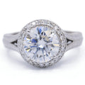 Direct top-down view of a 3 carat round lab grown diamond engagement ring with a milgrain halo and split-shank band.