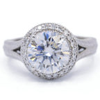 Direct top-down view of a 3 carat round lab grown diamond engagement ring with a milgrain halo and split-shank band.