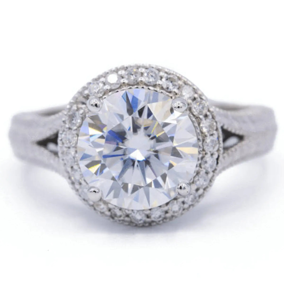 Direct top-down view of a 3 carat round lab grown diamond engagement ring with a milgrain halo and split-shank band.