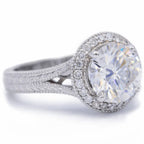 Perspective angle view of a 3 CT round lab created diamond halo ring featuring a hand-engraved split-shank band.
