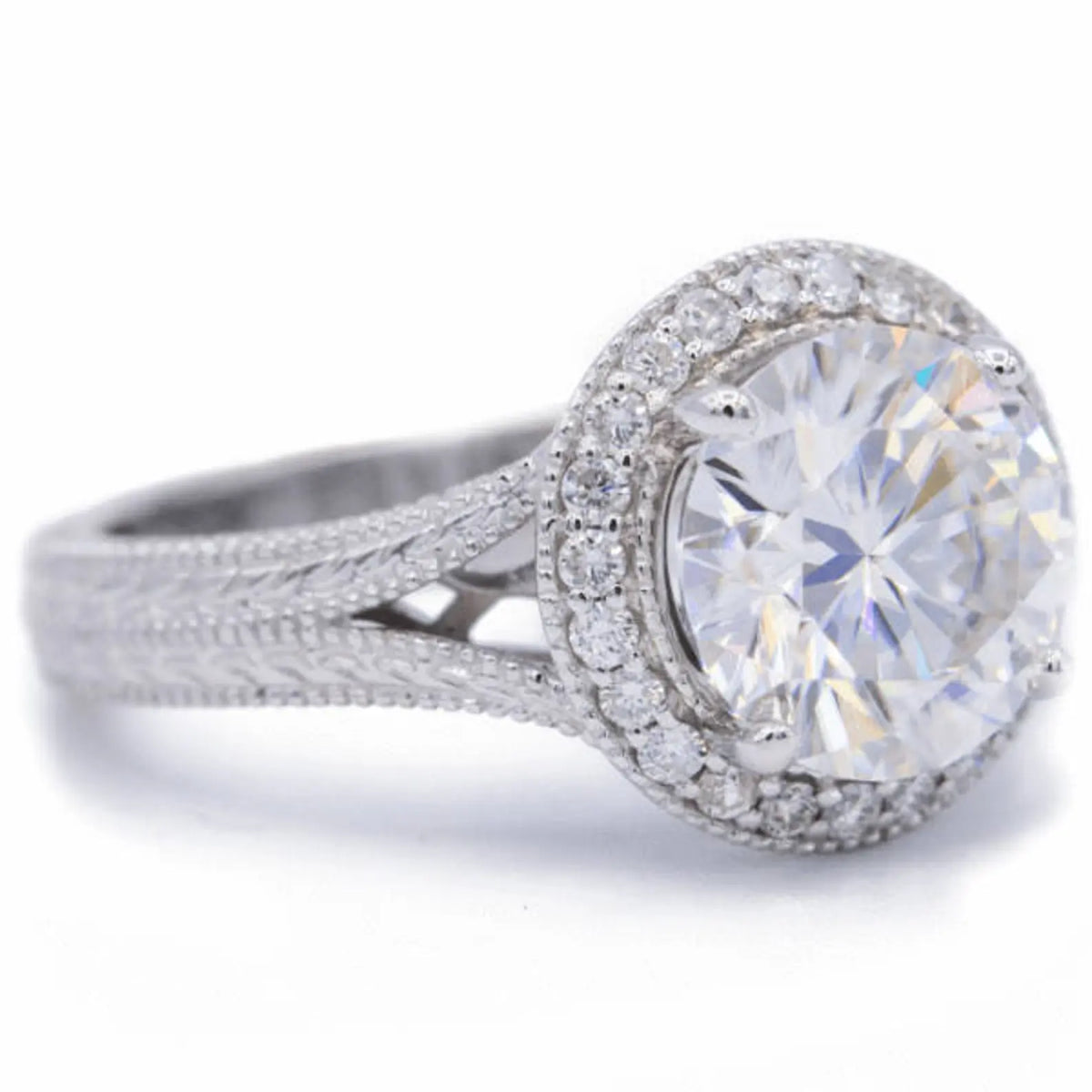 Perspective angle view of a 3 CT round lab created diamond halo ring featuring a hand-engraved split-shank band.