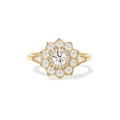 Studio portrait of a 1.5 carat round lab created diamond flower halo engagement ring set in 14K yellow gold.