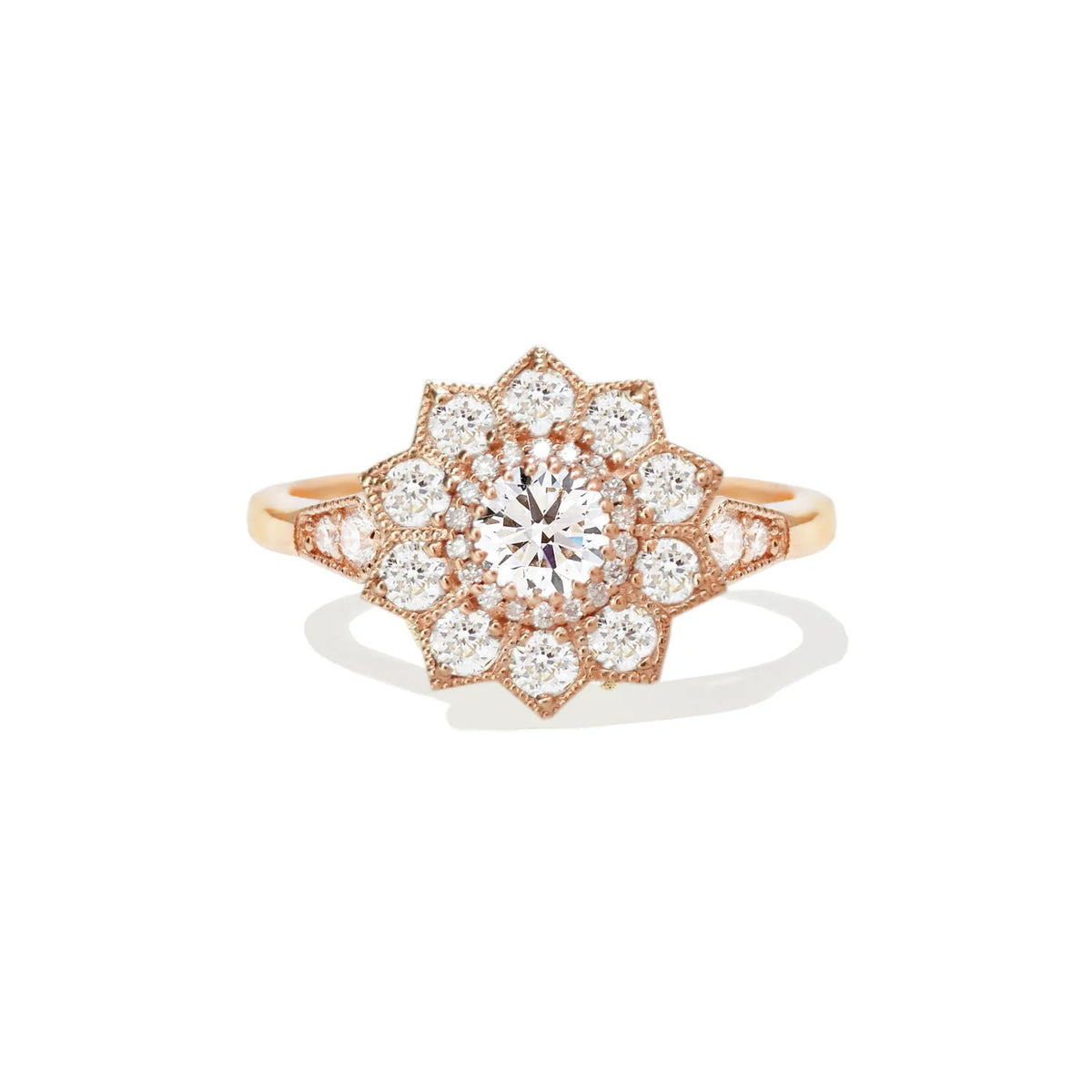 Studio portrait of a 1.5 CT round lab grown diamond starburst floral halo engagement ring in solid rose gold.
