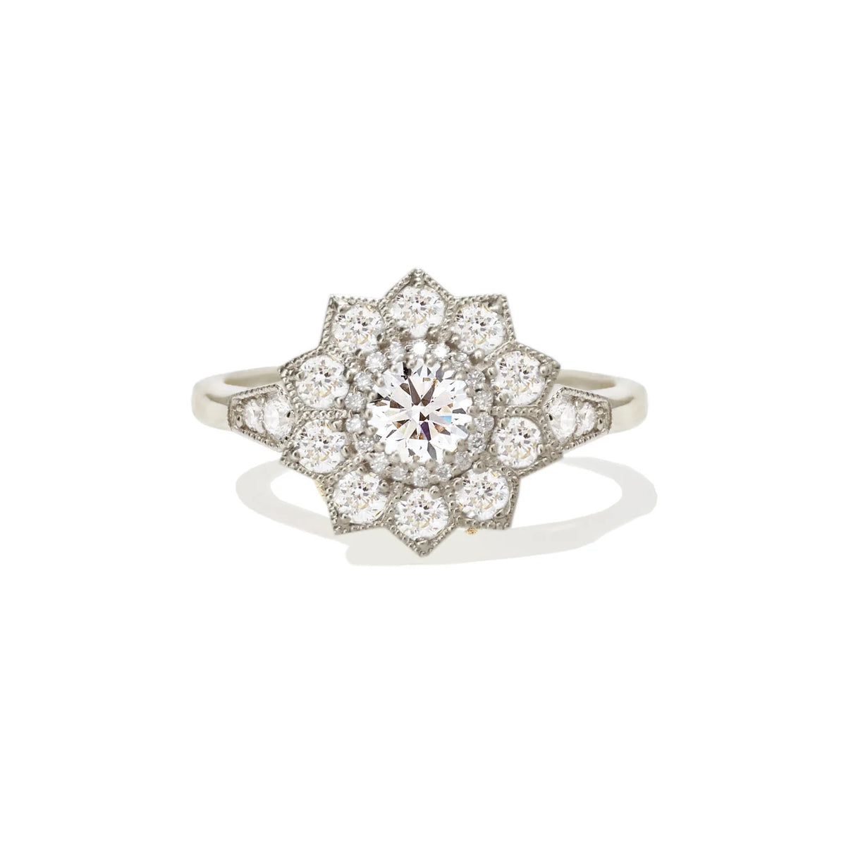 Studio portrait of a 1.5 CT round lab grown diamond starburst floral halo ring in white gold or platinum setting.