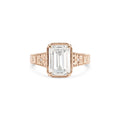 Studio product shot of a 3 carat emerald cut lab created diamond vintage engraved milgrain bezel ring in solid rose gold.