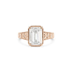 Studio product shot of a 3 carat emerald cut lab created diamond vintage engraved milgrain bezel ring in solid rose gold.