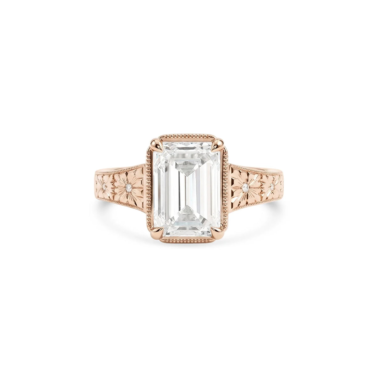 Studio product shot of a 3 carat emerald cut lab created diamond vintage engraved milgrain bezel ring in solid rose gold.