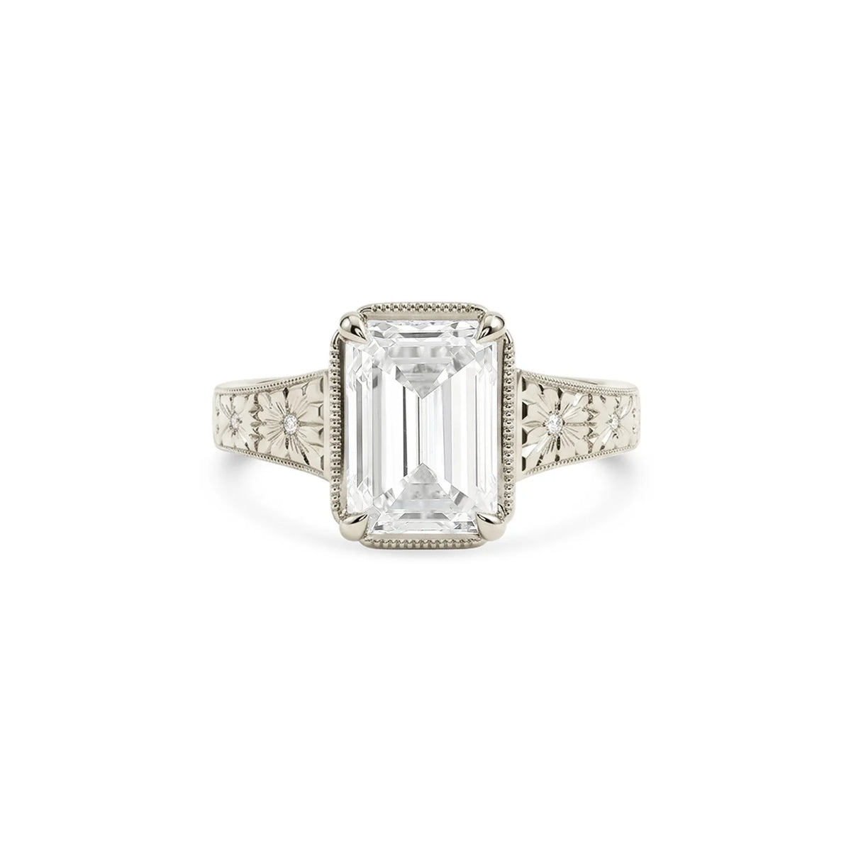 Studio product shot of a 3 CT emerald cut lab grown diamond engagement ring with floral milgrain bezel in white gold or platinum.