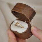 Angled profile view of a 2 CT round lab diamond vintage filigree ring inside an open wooden velvet ring box.