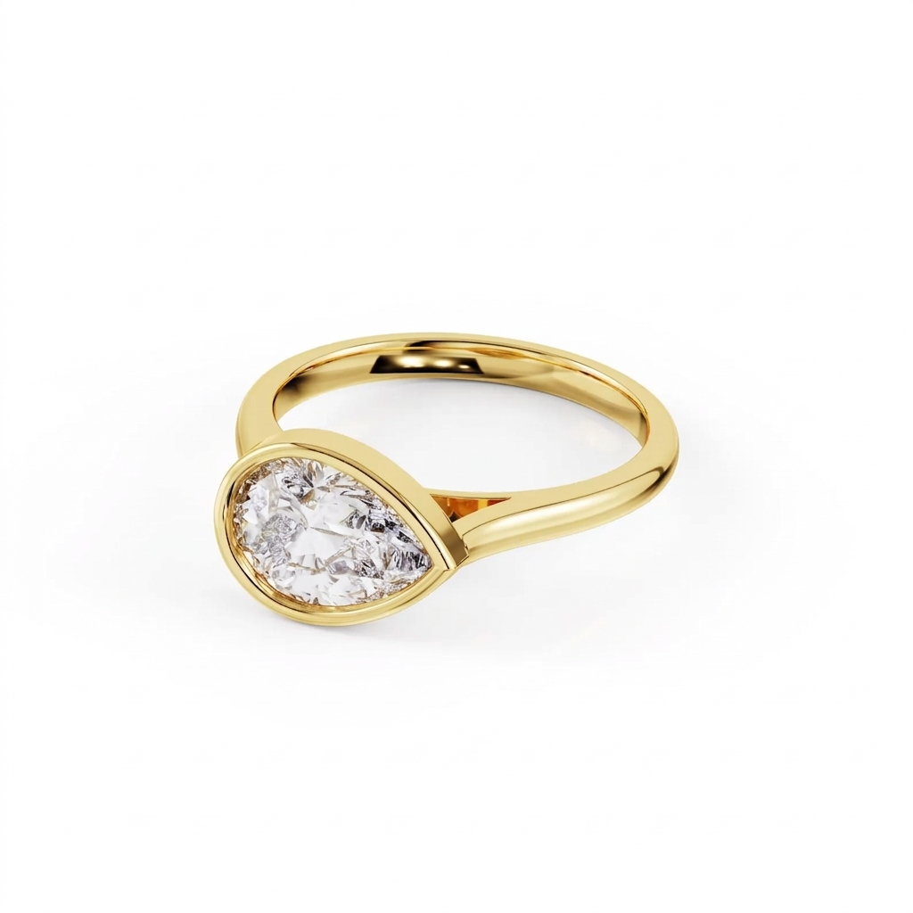 Three-quarter angled perspective shot of a 2 carat East-West pear cut lab grown diamond engagement ring in polished yellow gold bezel.