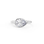 Top angle of a 2 carat horizontally set pear lab diamond ring in a sleek white gold bezel setting.