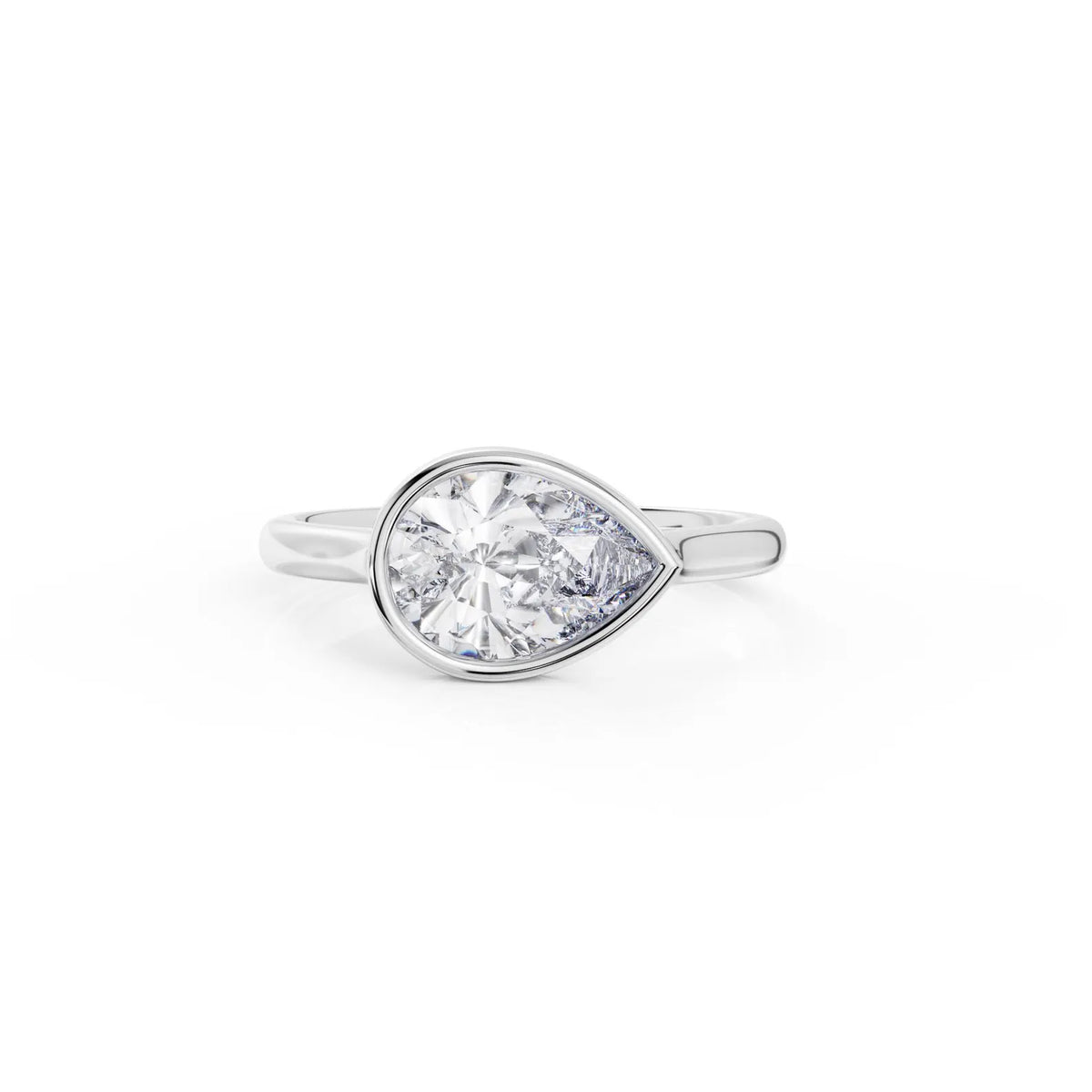 Top angle of a 2 carat horizontally set pear lab diamond ring in a sleek white gold bezel setting.