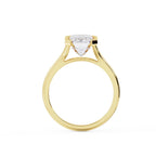 Direct side elevation shot of a 3 carat emerald cut lab diamond ring showing the high cathedral arch bridge in yellow gold.