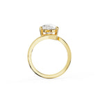 Side view of a 2 carat pear lab grown diamond engagement ring with a yellow gold bypass wrap band.
